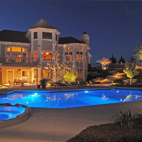 Outdoor lighting illuminating a backyard pond and water feature at night Outdoor lighting illuminating a backyard pond and water feature at night